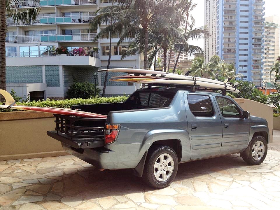 A truck with surfboards in the back of it.